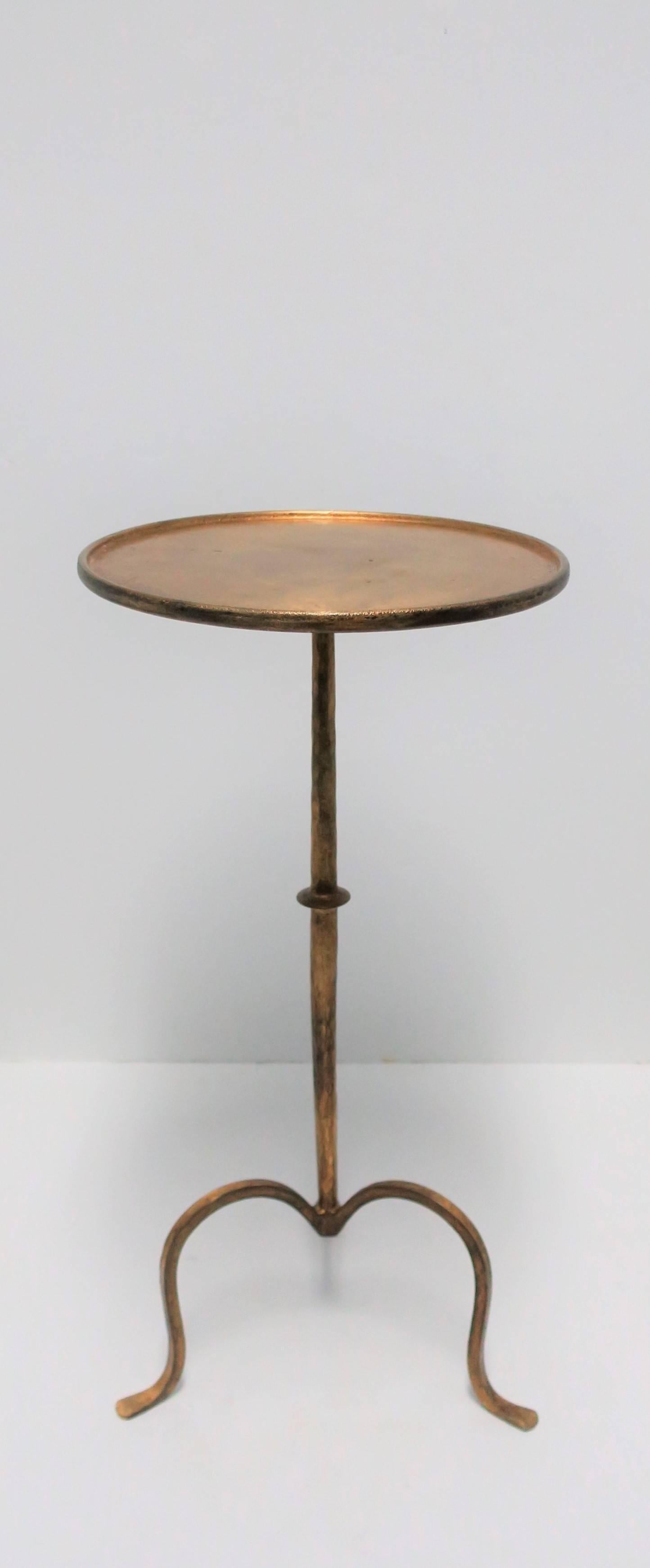 A beautiful and substantial gold gilt metal round side table with tri-pod leg base, circa 21st Century. 

Side table measures: 12 in. Diameter x 24 in. H

Item available here online. By request, item can be made available by appointment to the Trade