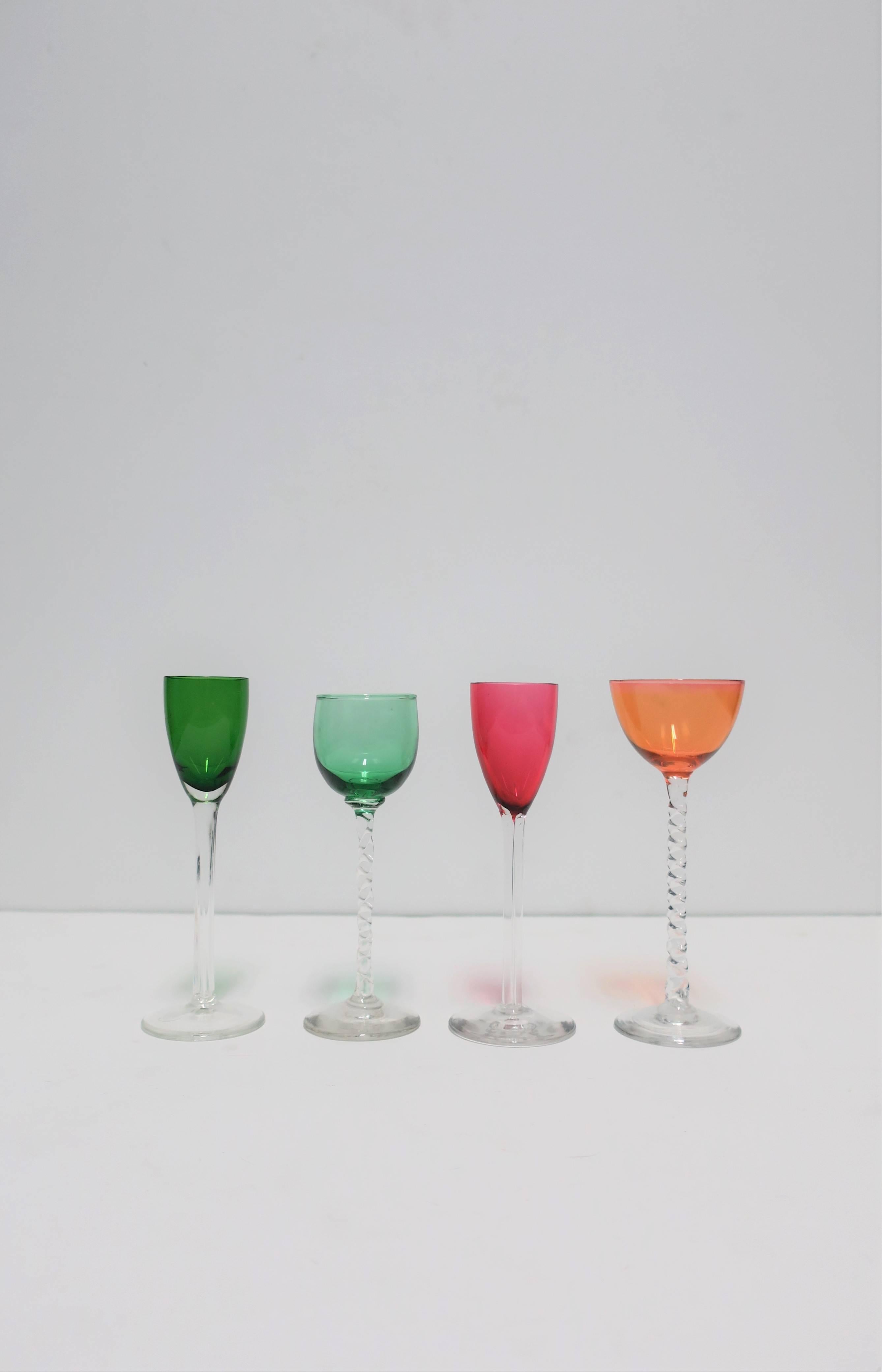 A beautiful set of 4 colorful art glass blown-glass cordial, aperitif liquor or spirits glasses. Colors include: dark green, light green, red/dark pink, and light orange. A great addition to any bar, bar cart, or entertainment area, etc. Tallest is
