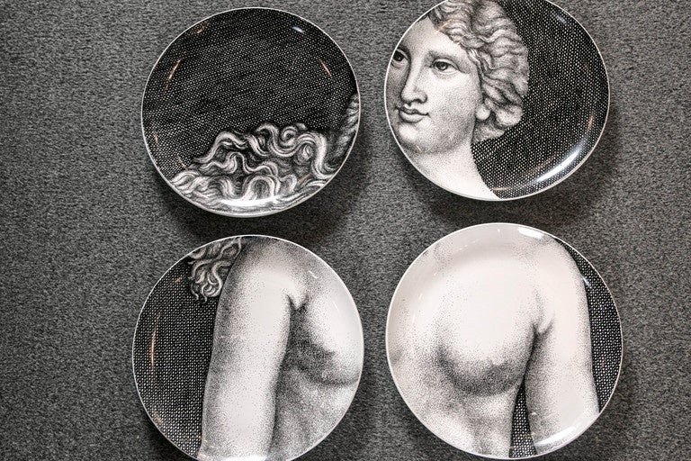 The complete set of 12 Fornasetti vintage black and white porcelain plates depicting Eve and the snake.
