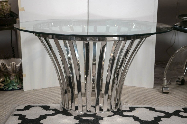 A modern coffee table with fluted shaped nickel-plated base.