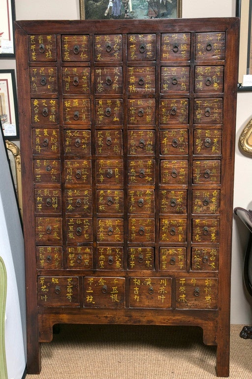 Chinese apothecary chest bearing inscriptions of herbs and spices in beautiful calligraphy. 52 drawers with pulls divided into three sections each.
