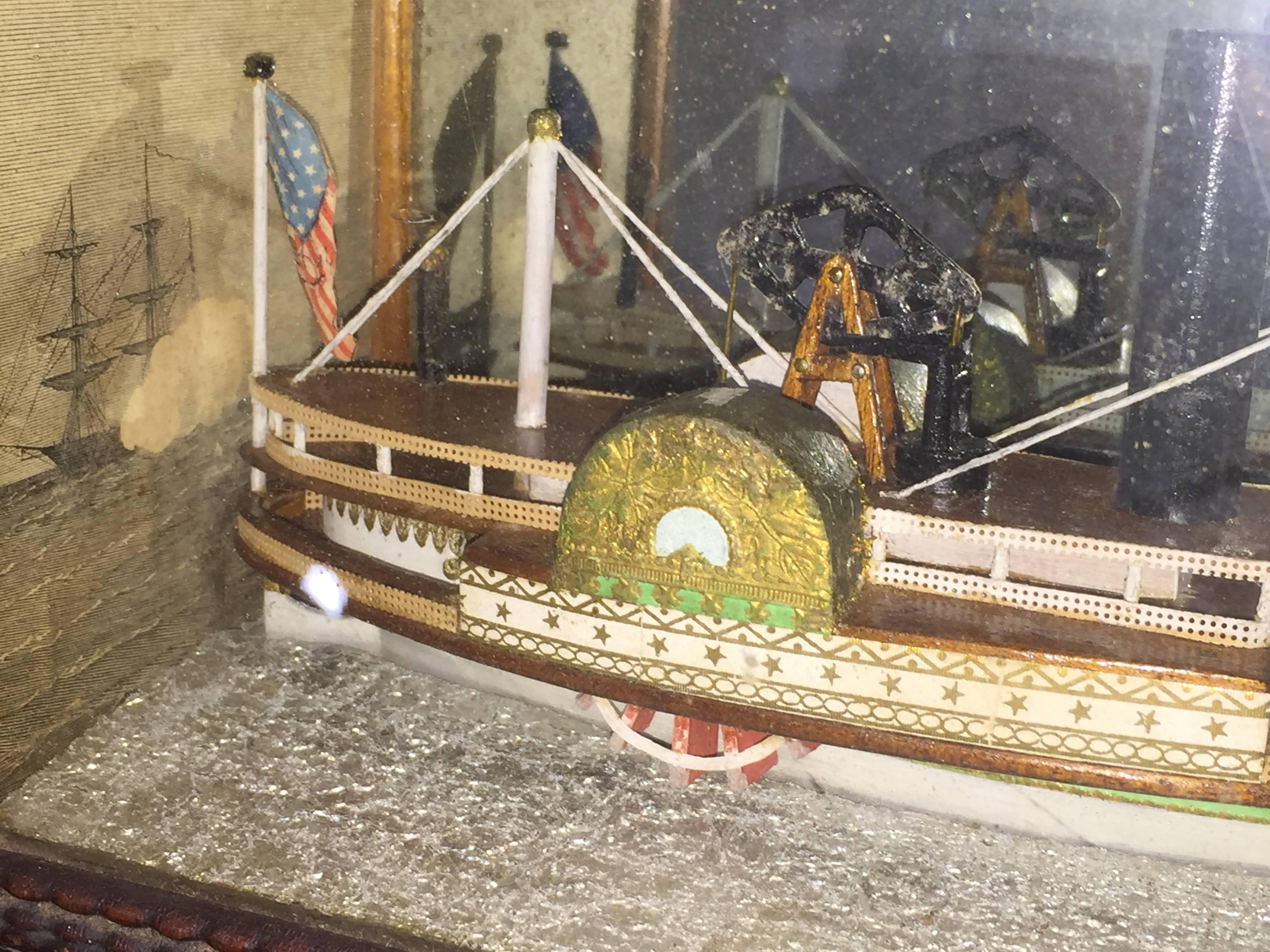This a very unusual especially diminutive diorama of a paddle wheel ship from New England with intricate detail marine scene wallpaper on sides and top and a hand-caned frame. The diorama most likely was made in Maine or New Hampshire in the late