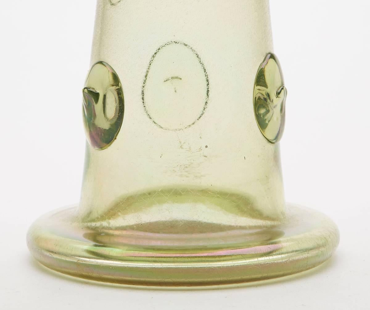 An Art Nouveau Austrian or Bohemian light green iridescent art glass vase on a fine craquelure ground with applied glass prunts. With rough pontil mark to the base the vase is attributed to Loetz or Kralik although is not marked.