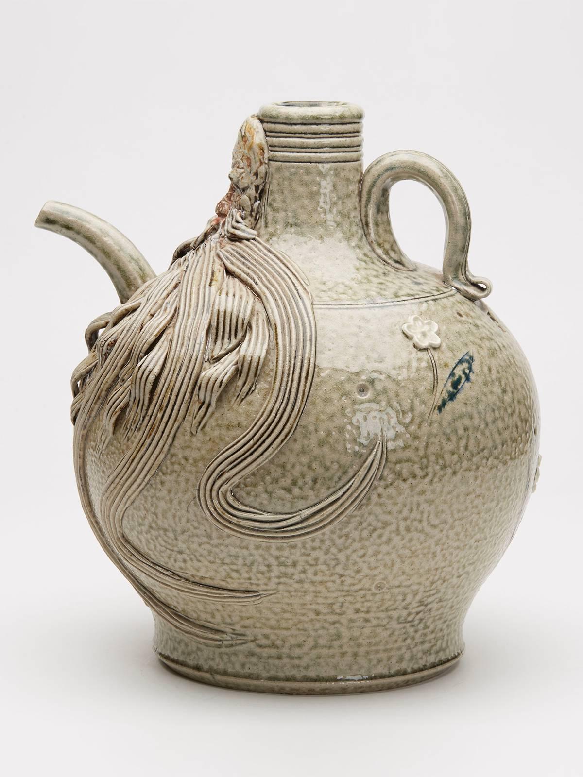A salt-glazed studio pottery Bellarmine ewer by Peter Meanley and dated 2010. The stoneware bellarmine is of rounded bulbous shape with a narrow raised top with a small handle attached to the shoulder with a mask above a pouring spout the beard