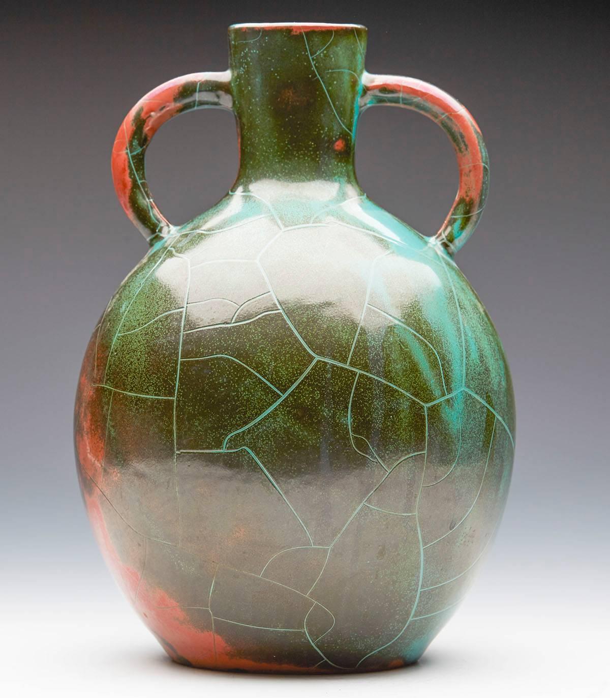 A large Art Deco German art pottery vase by Paul Dresler made at the Grootenburg studio. This stylish twin handled earthenware vase is of rounded bulbous shape and decorated Dresler's Classic copper reduction glaze in tones of red and green with