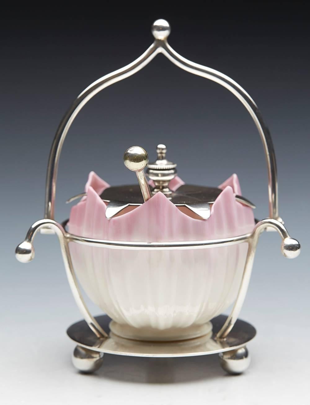 An Aesthetic Movement Grainger Worcester sucrier with a fitted silver plated swing handle Stand dated 1899. The very finely made porcelain sucrier has a ribbed flower bud shaped body applied with blush pink finish. The container sits neatly within a