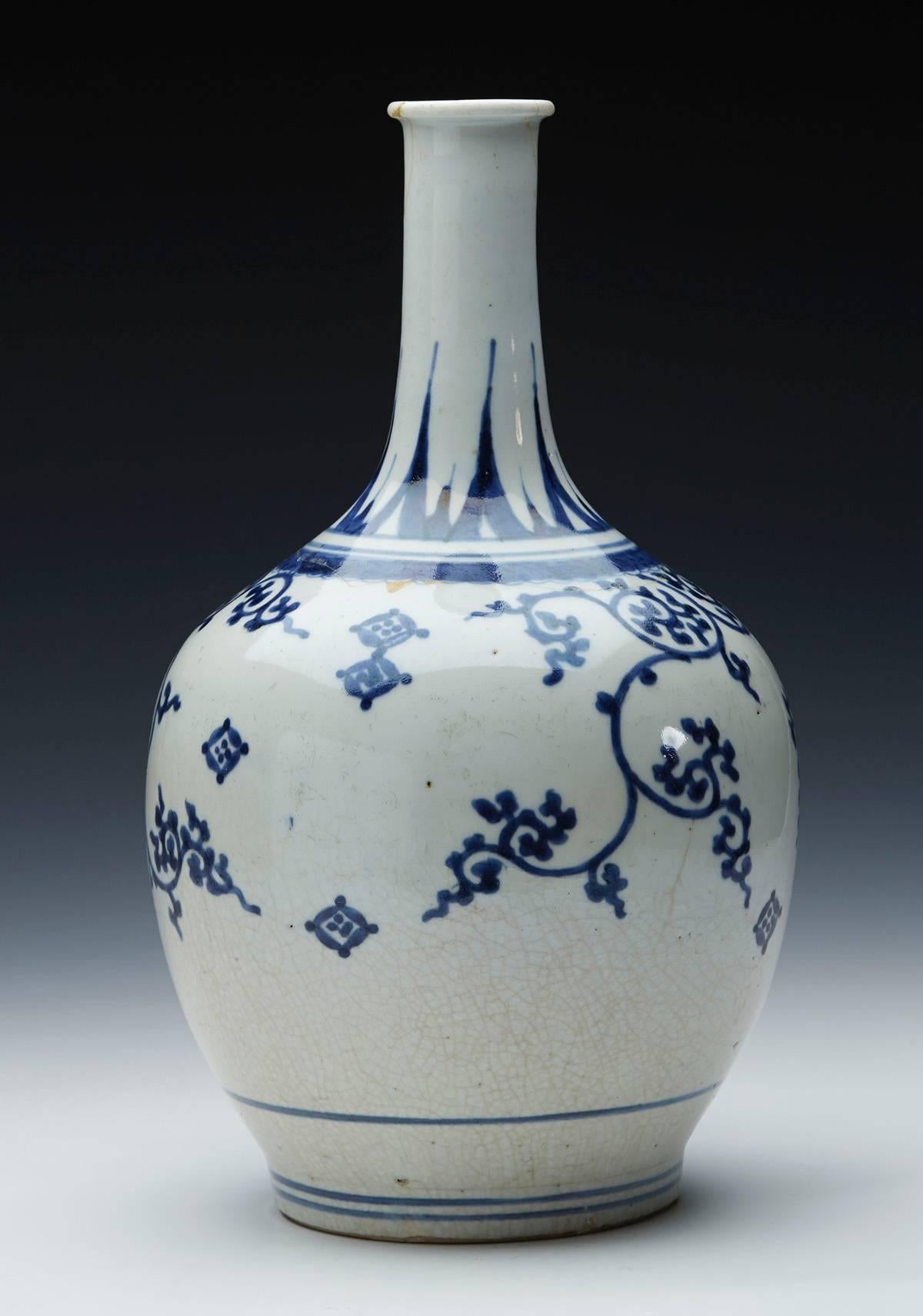A rare antique Japanese Imari blue and white painted porcelain bottle shaped vase of large baluster shape standing on a narrow rounded unglazed foot. From a Japanese 17th century collection of similar examples all of which have been sold previously