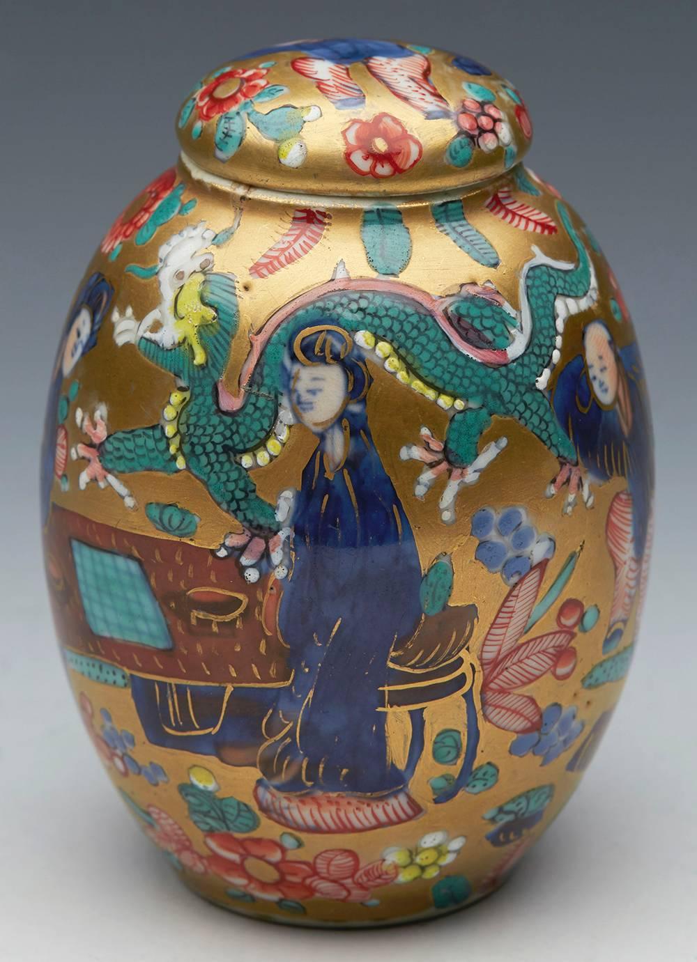 An antique Chinese Kangxi lidded jar hand-painted with two ladies playing a board game with a five claw scrolling dragon dating 1662-1722. This finely made porcelain jar stands on a narrow rounded unglazed foot rim with a recessed base. The rounded