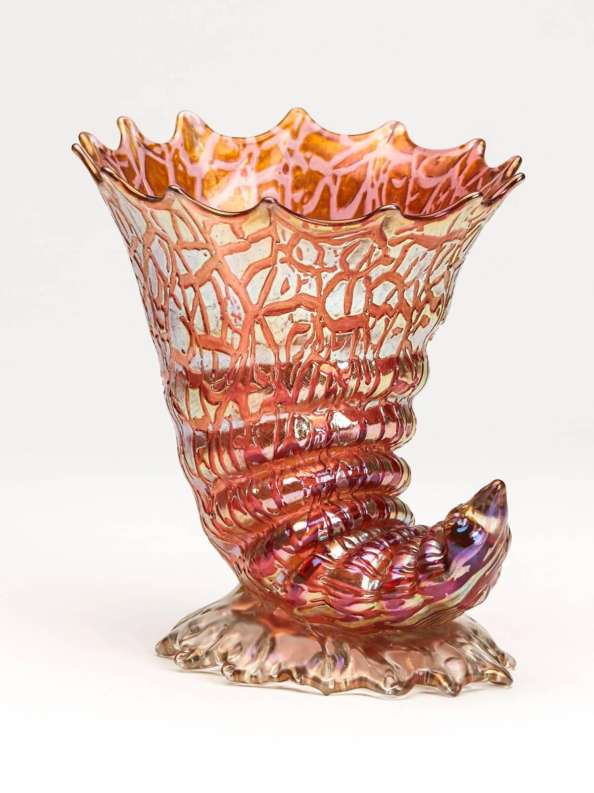 A stunning and rare Art Nouveau shell shaped cornucopia art glass vase decorated, we believe in the Chine design with a golden iridescent finish over a cranberry colored glass body on an iridescent foot. The shell shape is one of the most sought
