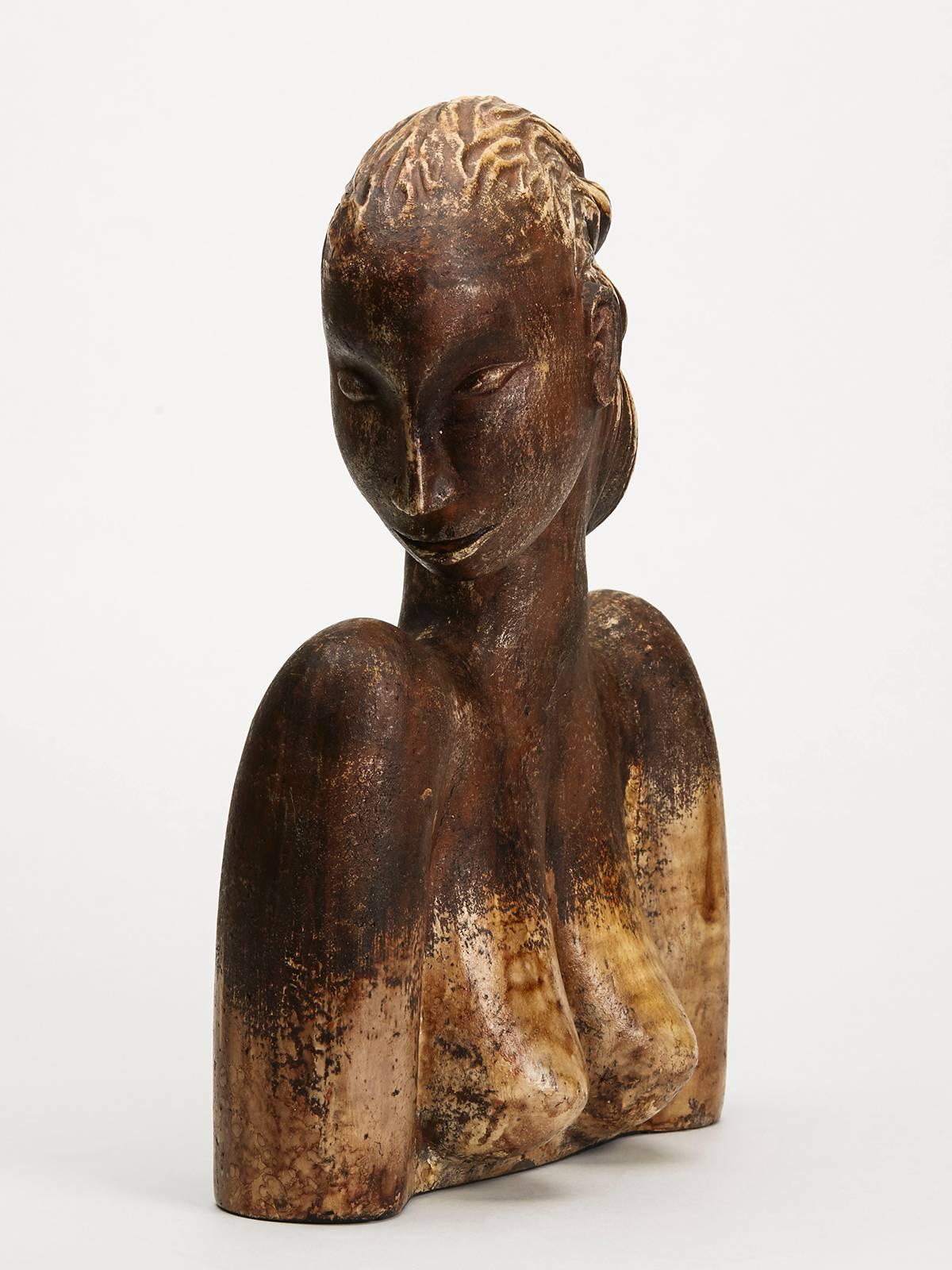 A stylish and large Continental terracotta profile bust of a lady looking sideways, the hollow and finely potted figure decorated in brown glazes. The sculptural figure is not marked.