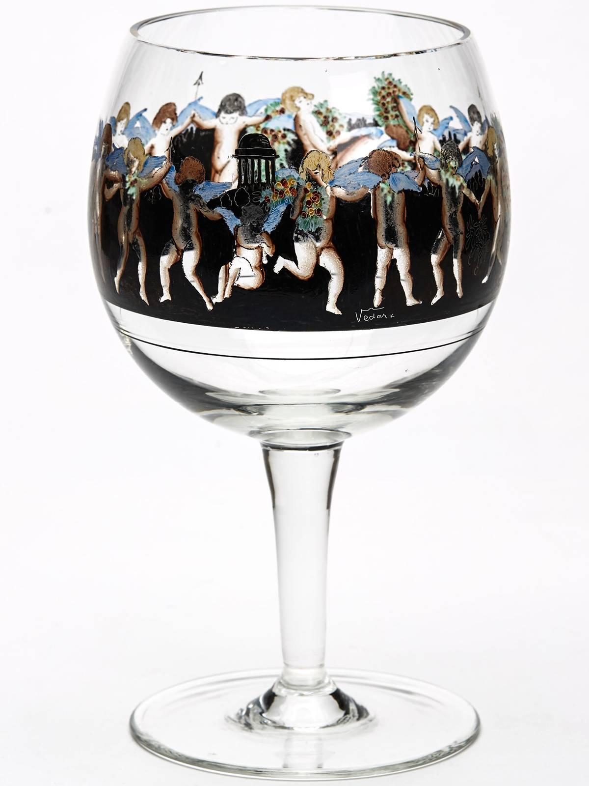 A stylish set six Art Deco style Italian glass stemmed goblets each decorated with a band of enamelled winged putti set against a black continuous landscape ground. The putti are painted in coloured enamels with finely painted detail and five of the
