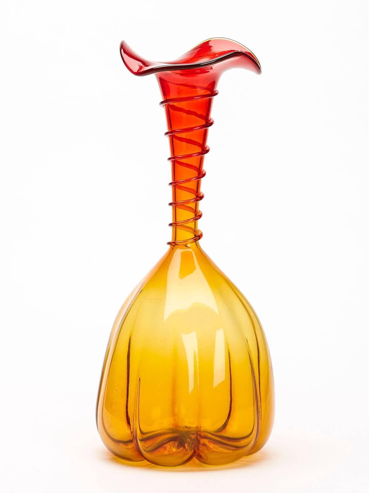 A very fine, stylish and unusual mallet shaped art glass vase in amberina orange and red glass the body of rounded gourd shape with ribs running up the body from the base and with a snake twist spiral applied to the trumpet shaped neck with a wide