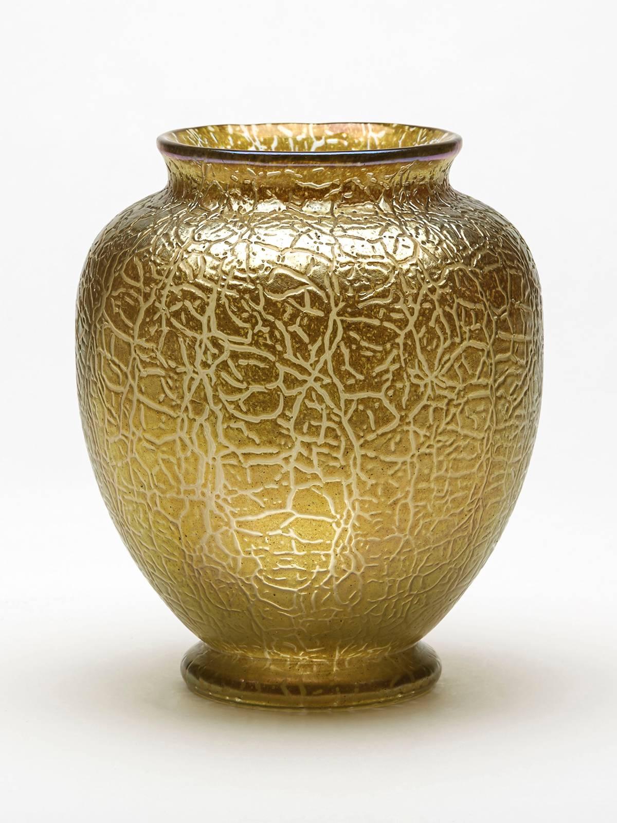 A stunning Art Nouveau art glass vase with a golden yellow crackle finish with iridescent hues. The rounded bulbous vase has a polished pontil mark to the base and is not marked.