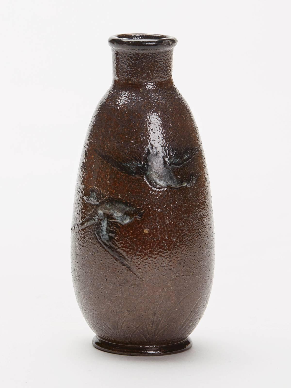 A miniature Arts & Crafts Martin Brothers stoneware vase by Edwin & Walter Martin of tall slender form incised and painted with geese flying above grasses highlighted in white on a dark brown ground. The vase has incised Martin Bros. London mark to