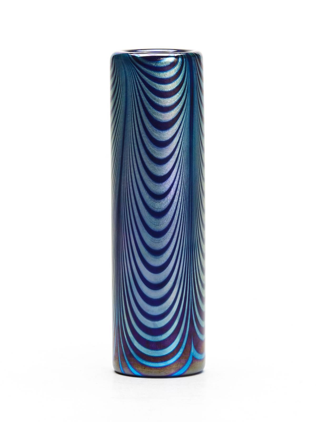 An absolutely stunning Art Nouveau Loetz Phanomen art glass vase with a wonderful iridescent peacock feather design on a blue glass ground. The elegant cylindrical vase is heavily made and has an appearance which would compliment any modern or