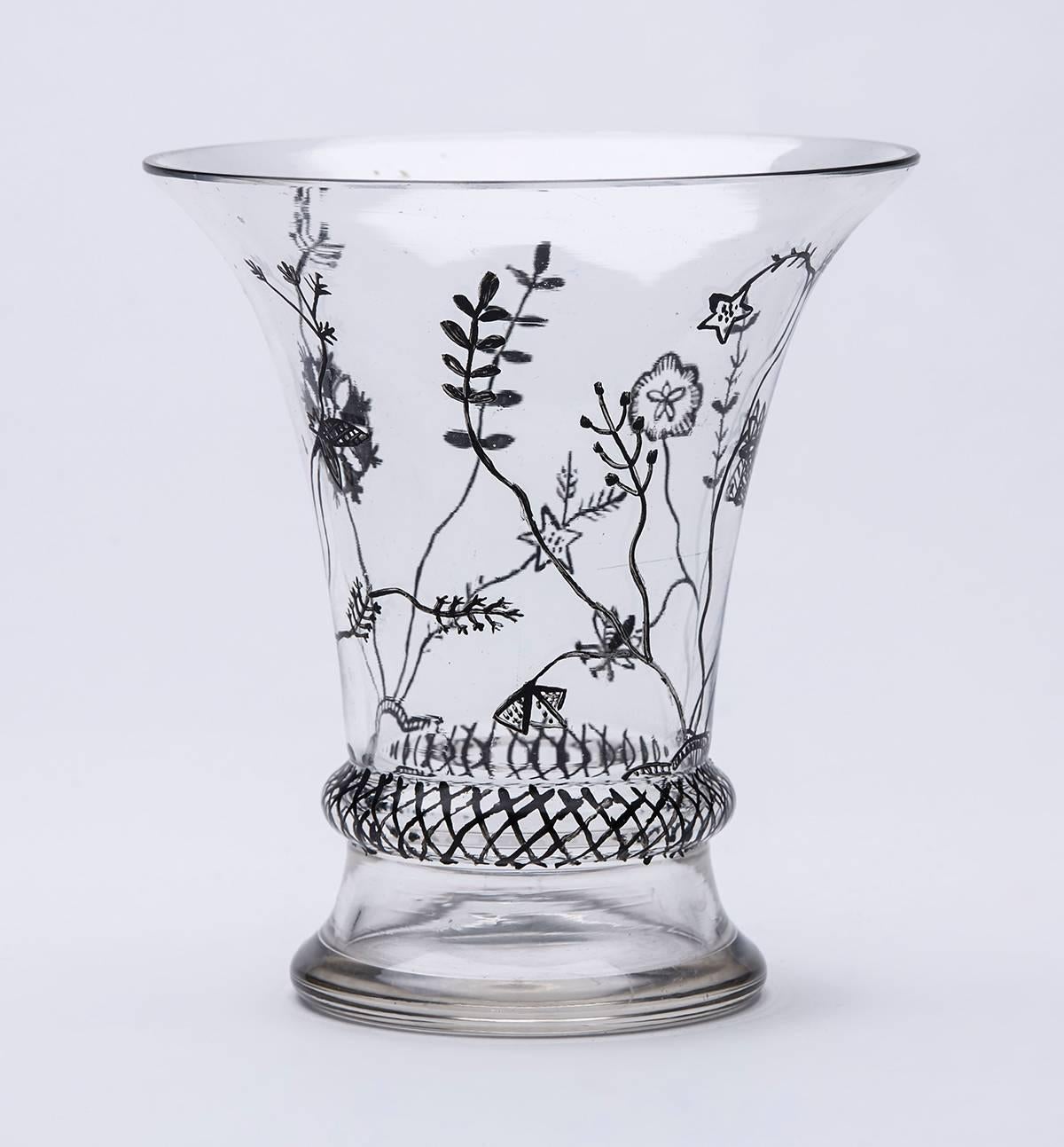 Fine and rare vintage Austrian art glass beaker shaped vase with a trumpet top applied with black enamel decoration probably made by Moser and possibly by Dacobert Peche for the Wiener Werkstatte. The vase is unmarked but typical of designs by the