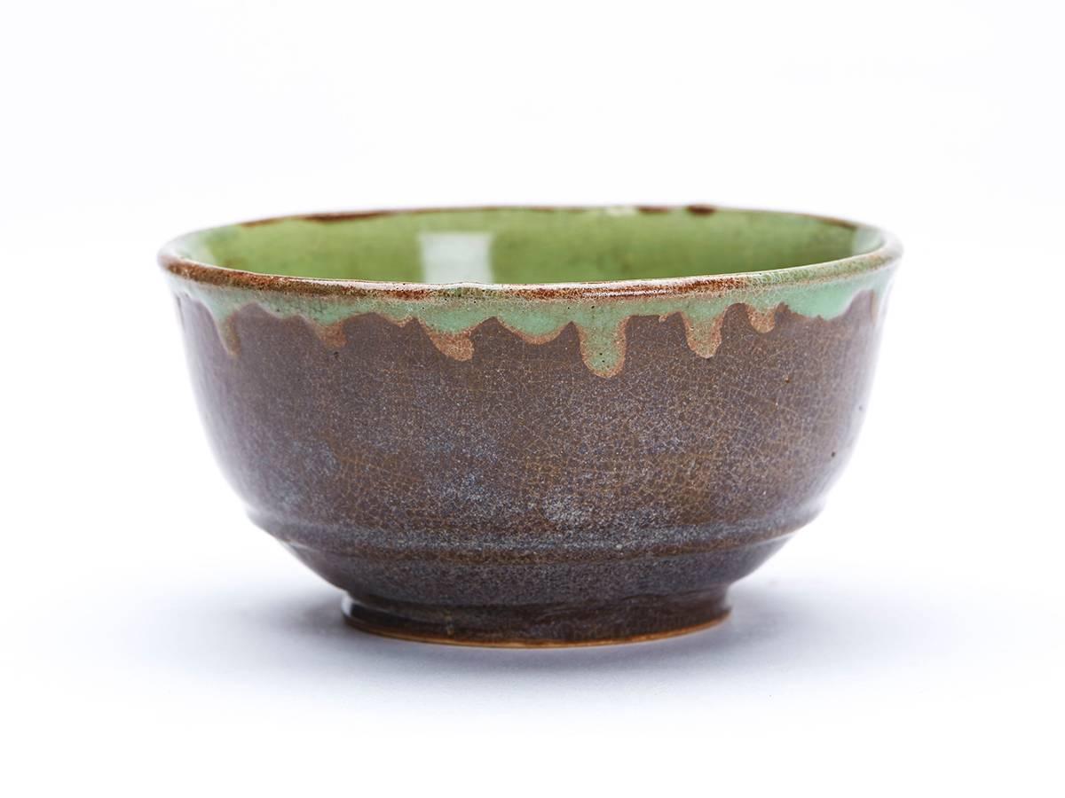 A stunning set six French Greber art pottery bowls of rounded form with a raised ridge above a narrow rounded unglazed foot. The stoneware bowls are decorated in brown stone colored glaze with green glazes to the inside and run slightly over the top