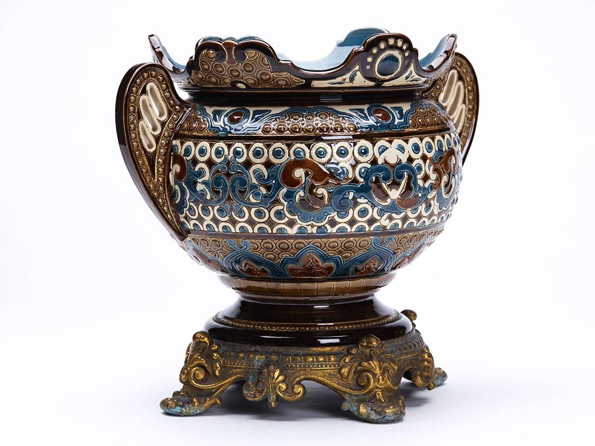 An antique ormolu-mounted Majolica twin handled planter or centre piece attributed to Wilhelm Schiller. The Majolica planter is of wide rounded form with a raised ornate rim and with pierced wing shape handles. The body is decorated in low relief