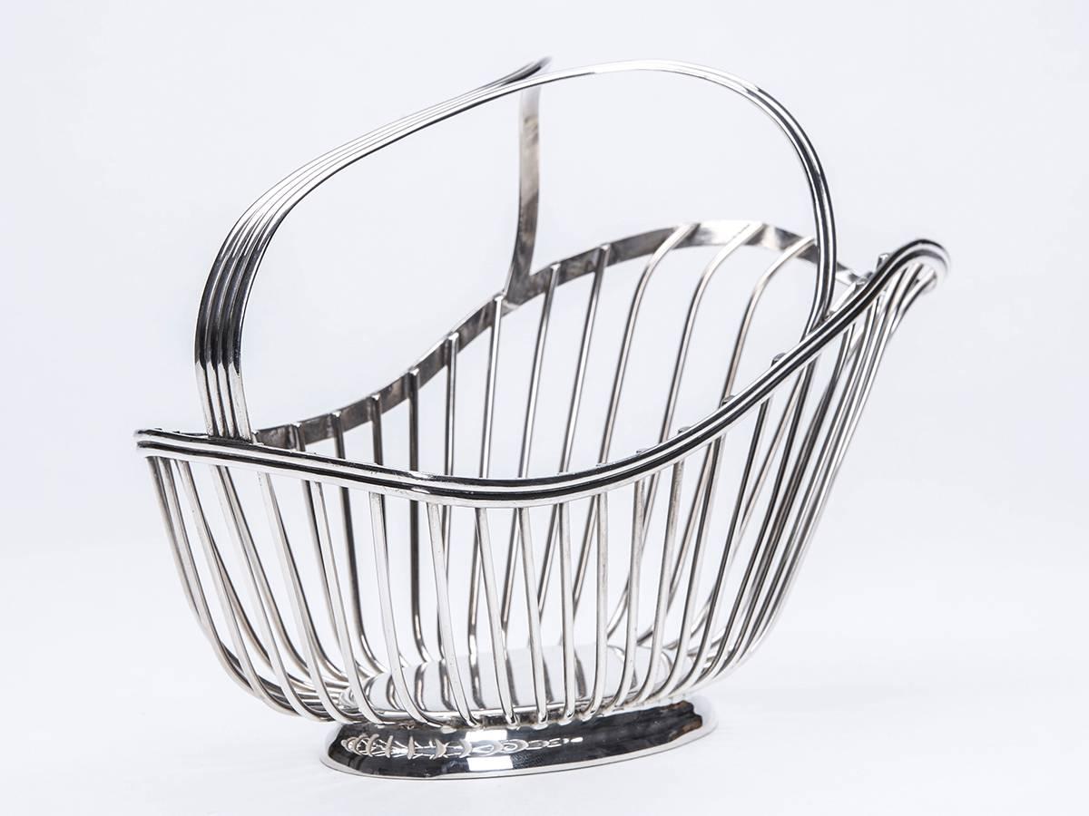 A stunning vintage French Christofle silver plated wine bottle holder and pourer. The open work basket shaped holder has a moulded flat handle standing on an oval base with impressed Christofle, France. Marks to the lower rim.