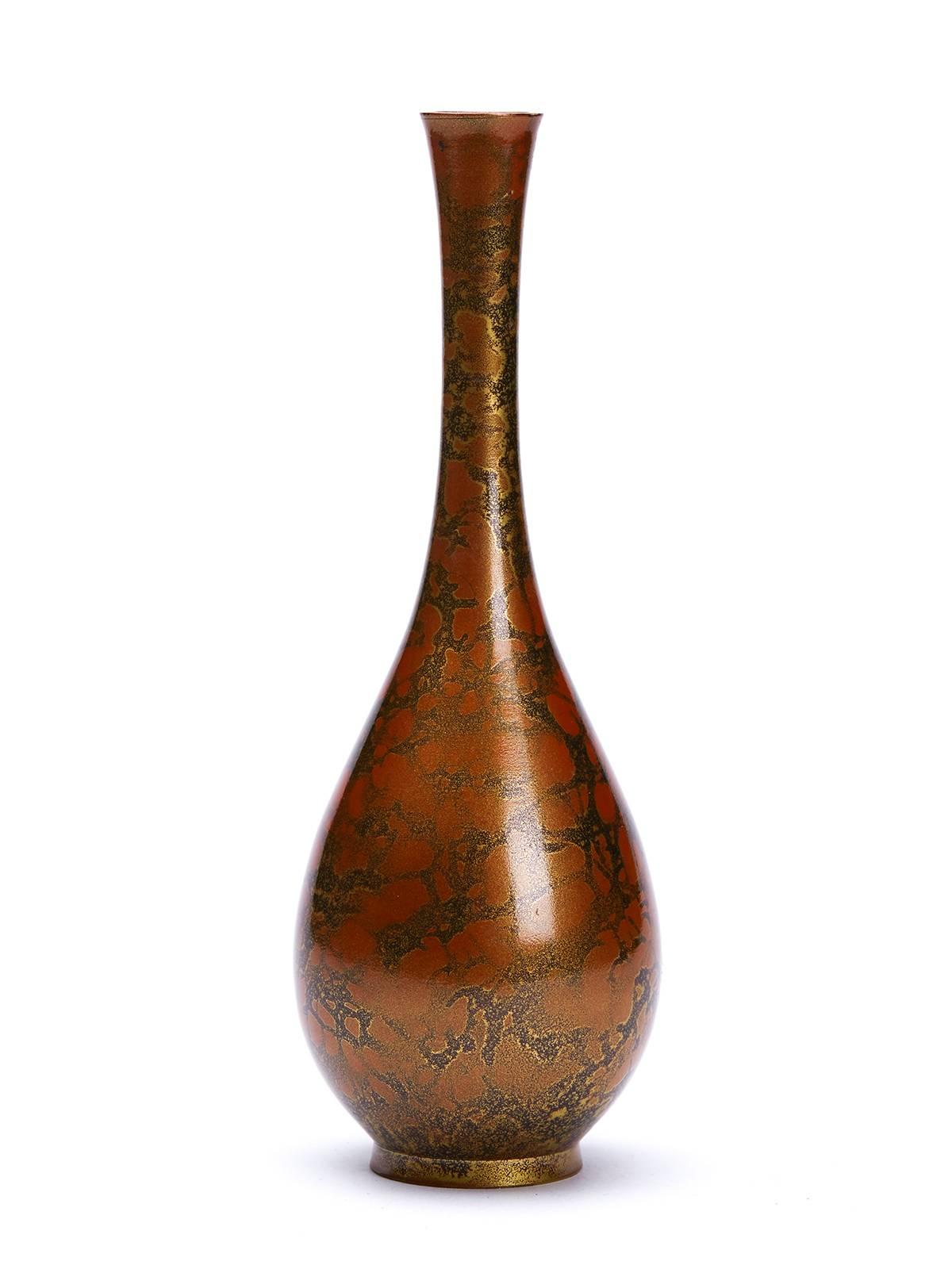 A vintage Japanese patinated solifleur bronze vase finely decorated with a mottled orange and gold pattern in a lacquered finish style. This stylish bronze vase of simple bottle form stands on a narrow rounded foot and is not marked.