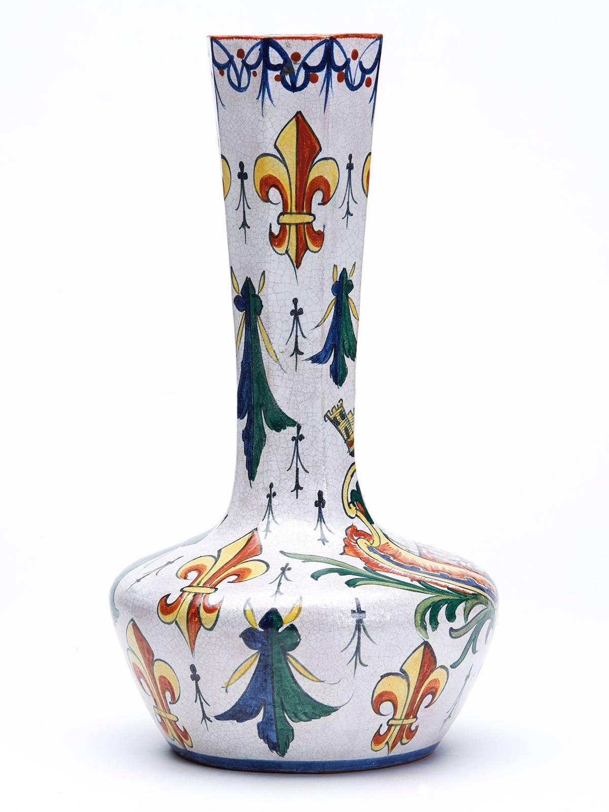 A fine antique continental pottery faience delft vase of bottle shape hand-painted in coloured enamels with an armorial crest and fleur de lys designs which may suggest that the vase is of French origin. This fine red earthenware vase has a squat