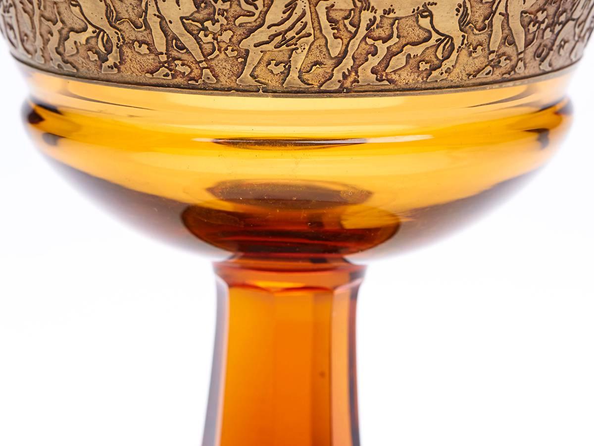 An Art Deco Moser 'oroplastic' acid etched pedestal amber glass bowl with a gold classical figural frieze around the bowl. Oroplastic was the term given to a technique patented by Moser in 1919 to create this type of pattern on its glass wares and