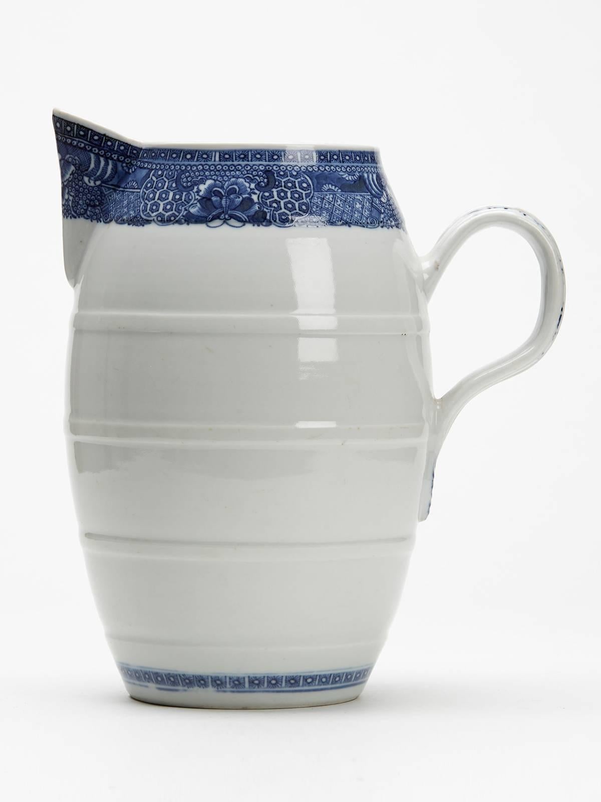 A fine and scarce antique Chinese late Qianlong large porcelain barrel shaped jug with moulded ribbed handled with leaf terminal and with blue and white decoration to the handle and around the upper rim. The jug is not marked.