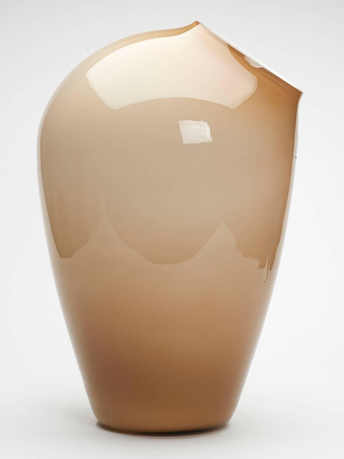 A large and stunning vintage German Schott Zweisel overlay glass vase with angled side cut opening with clear cased brown over white glass lining. The handblown vase has an original part paper label attached with acid etched makers marks to the base.