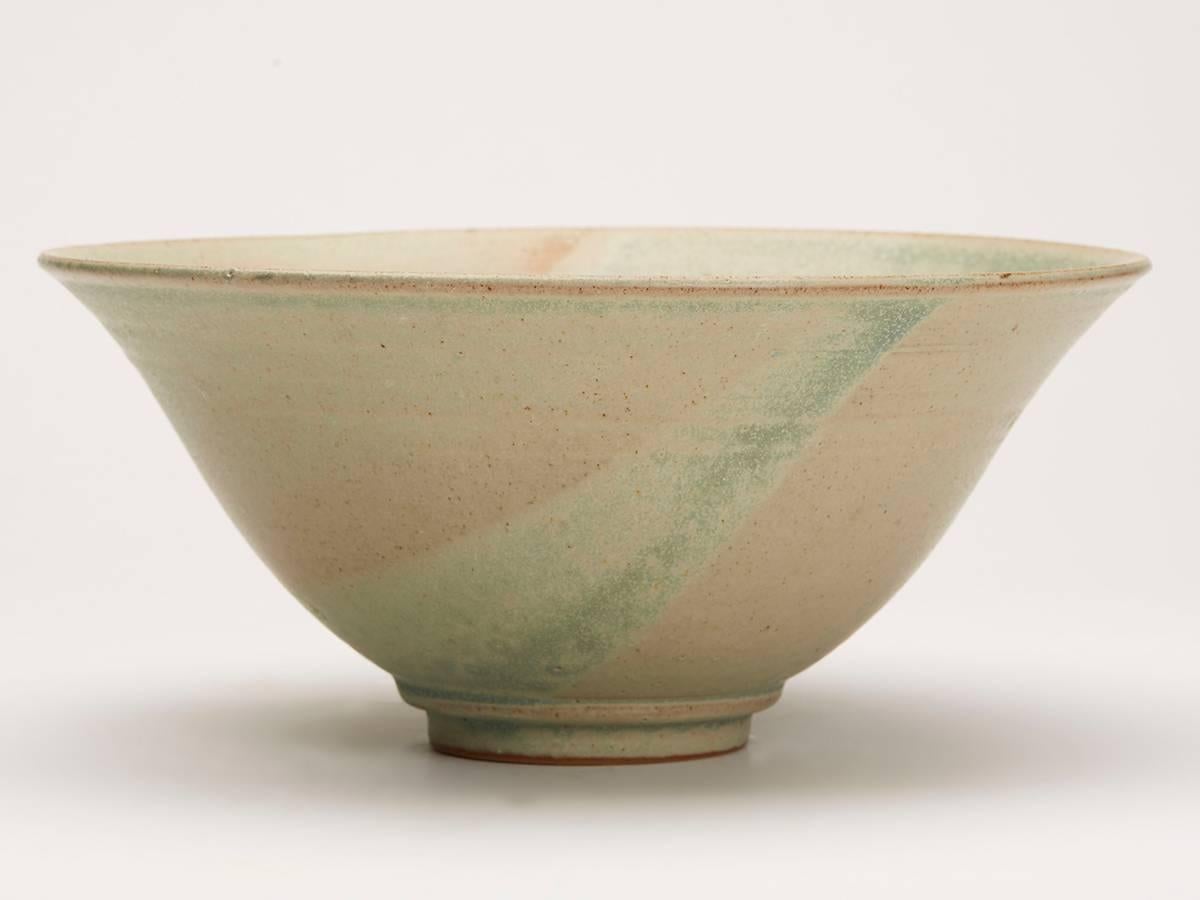 A fine vintage Studio Pottery bowl decorated in green glazes by Ken Halsall (b.1928) and made at the Light Trees pottery. The rounded shaped bowl stands on a narrow rounded foot and is finely potted and decorated in matted green glazes with slight