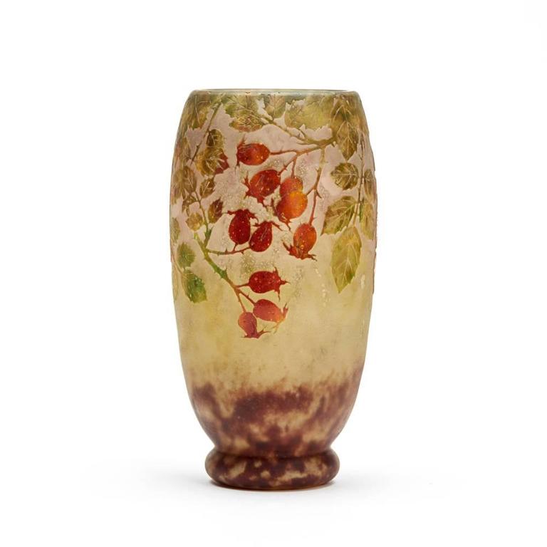 A stunning French Art Nouveau Daum Frères rosehip cameo glass vase wheel cut with raised designs in colored enamels on an etched ground with a raised cameo 'Daum Nancy' and a croix de Lorraine mark.