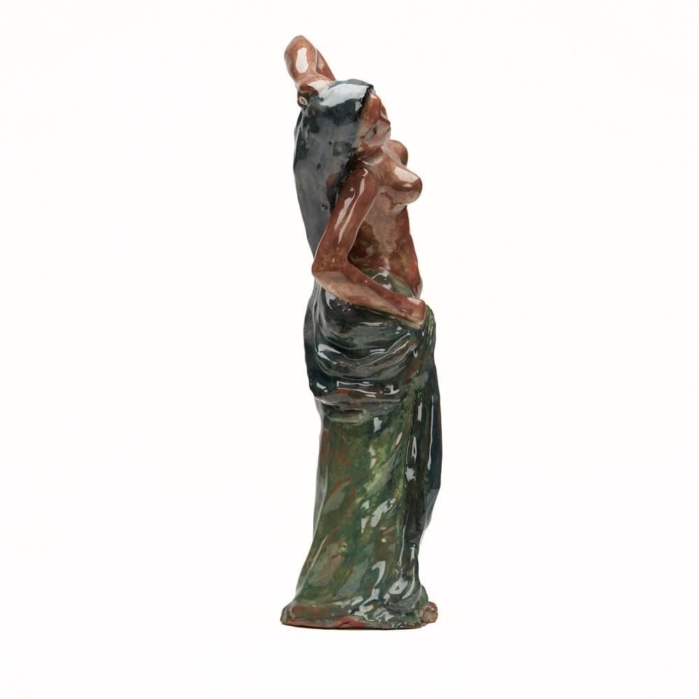 A very fine and stylish Austrian attributed, possibly Wiener Werkstatte, art pottery figure of semi naked dancer in the manner of Paul Gauguin. The figure is heavily and solidly potted in terracotta clay and depicts the dancer wearing a long veil