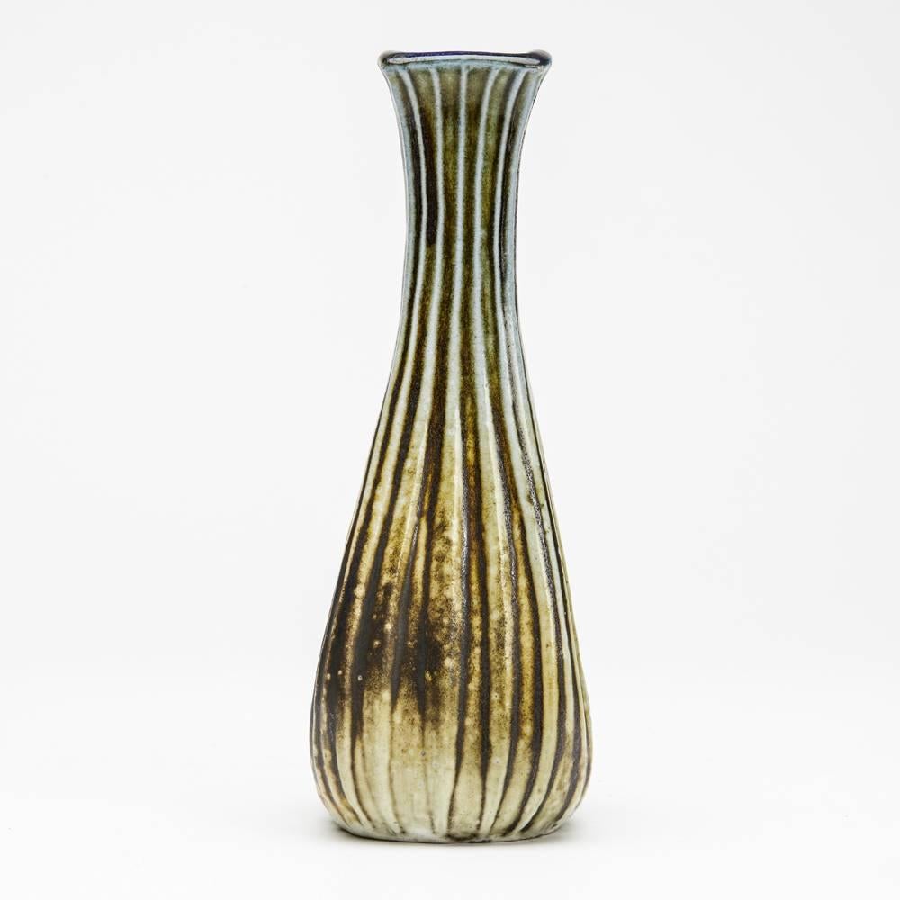A stunning Martin Brothers stoneware ribbed gourd vase by Robert Wallace Martin of tapering square section with vertical ribs. The vase is glazed olive green and buff with blue glazed top rim and to the inside of the vase. Incised R W Martin Bros