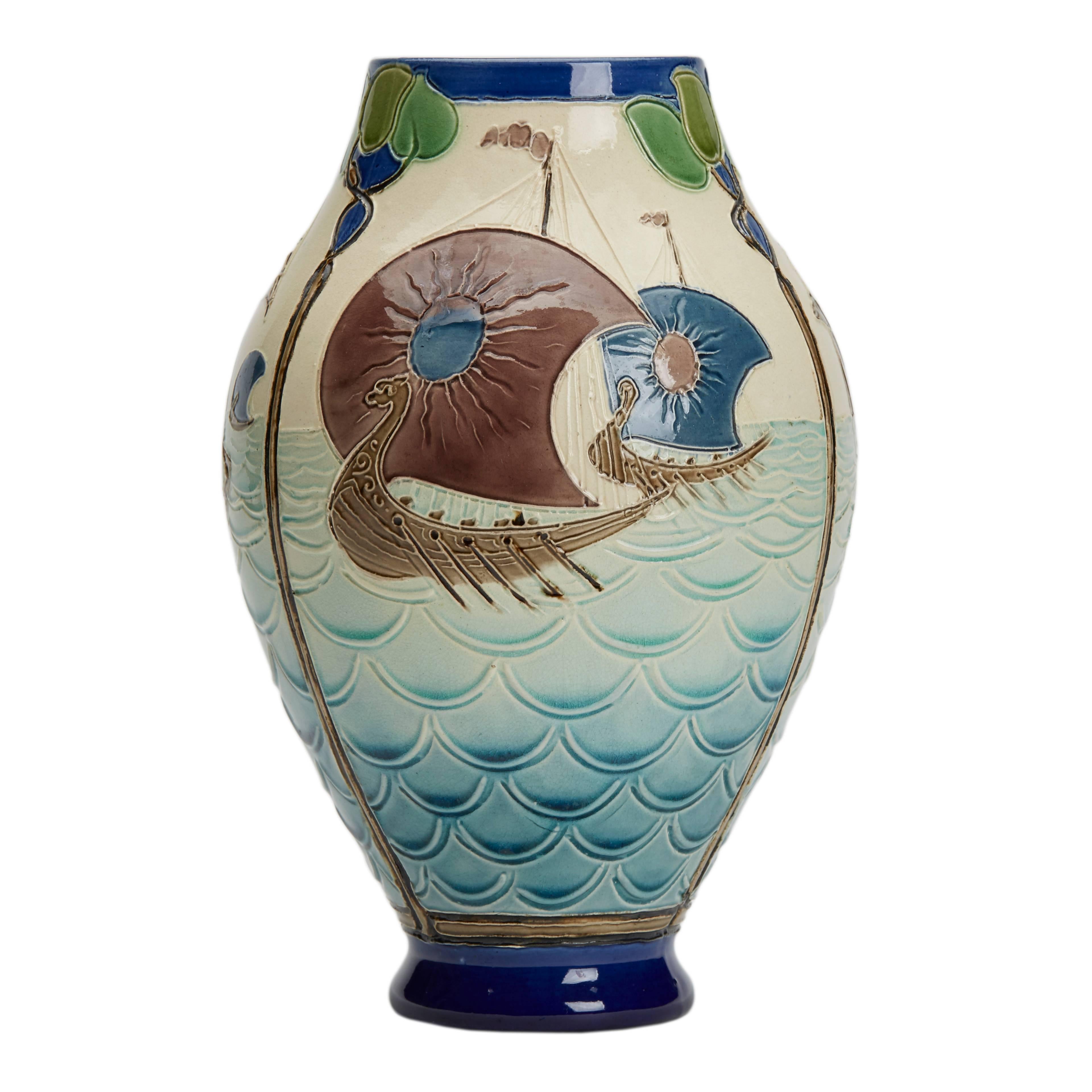 A rare Burmantofts Faience Partie-Color art pottery vase decorated with Viking longboats at sea designed by Joseph Walmsley. The vase is of swollen bulbous form with incised and low relief modeling divided into three panels each with a variant