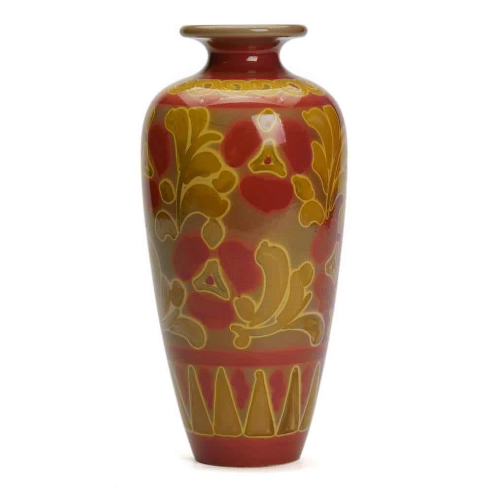 A stunning and rare Burmantofts Faience floral vase by Joseph Walmsley, a tall elegant vase of shouldered form, painted stylized flowers and foliage in golden lustre on a vivid red ground along with a painted JW monogram to the base. 

Provenance: