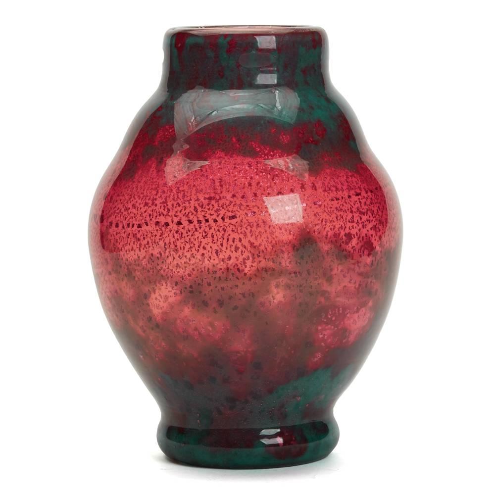 A stunning and rare early Art Deco (1910-1935) French Muller Freres Lunneville art glass vase. The vase of large shaped bulbous form is decorated with a silver fleck pattern cased between clear and cranberry colored glass with blue inclusions around