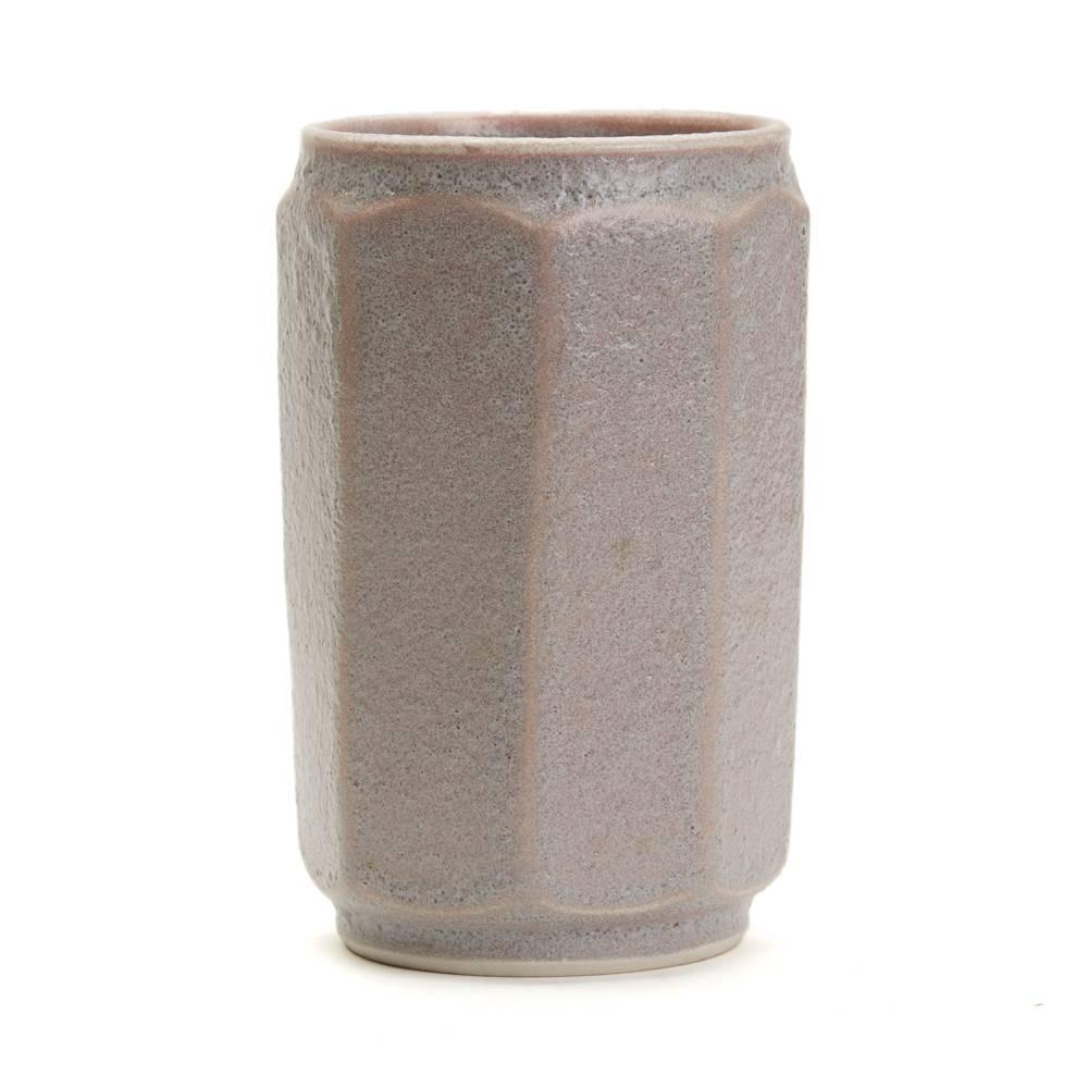 A stylish vintage Studio Pottery vase of octagonal cylindrical form made at Loughton Pottery by Thomas Weir Howard. The stoneware vase is decorated in grey textured lava style glazes over a pink colored ground and has an unglazed base with an
