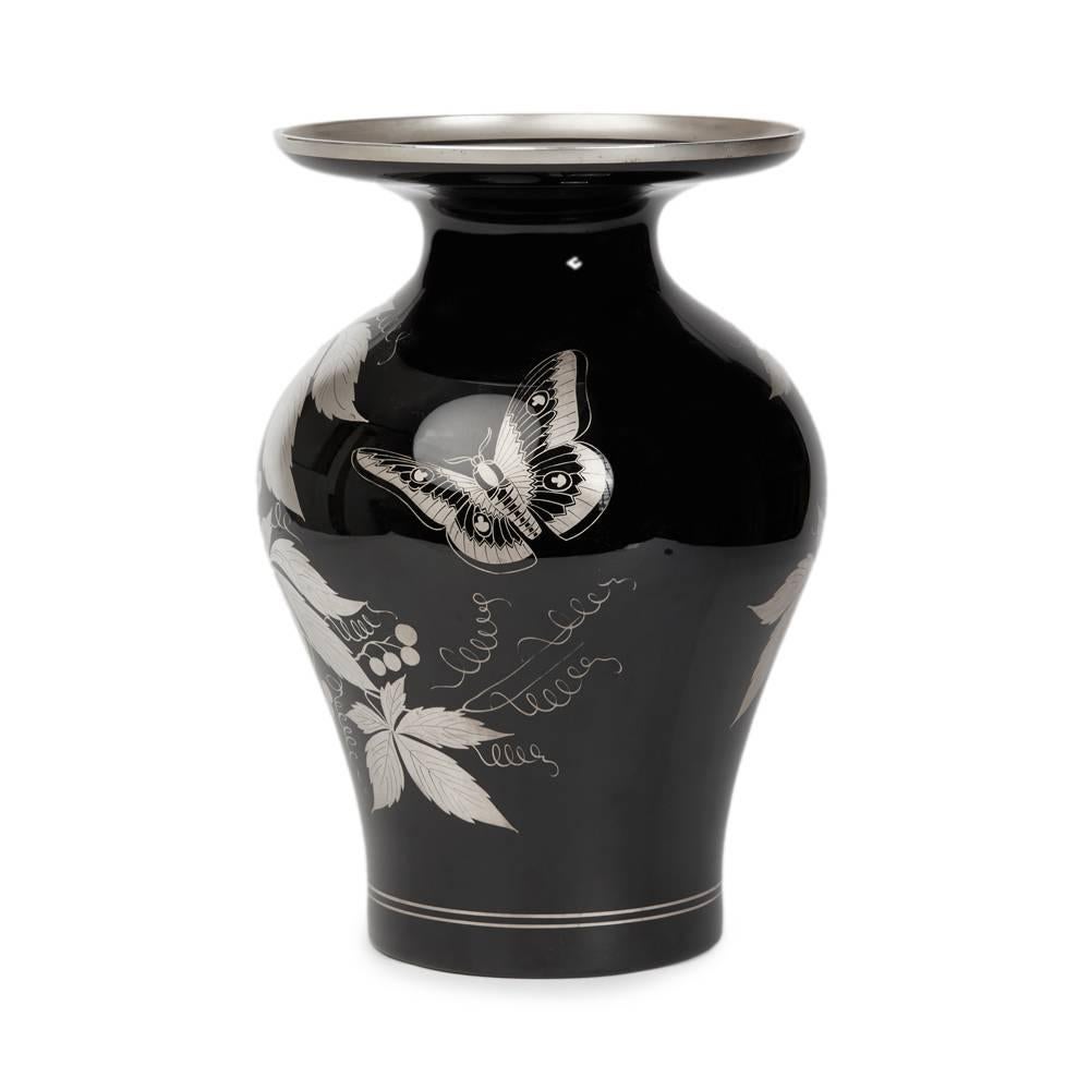 An exceptional vintage Art Deco Italian Murano art glass vase of bulbous shape with narrow neck and wide flat top with a raised rim. The vase blown in 'black' glass is overlaid with silver decoration with a butterfly and fruiting vines with a line