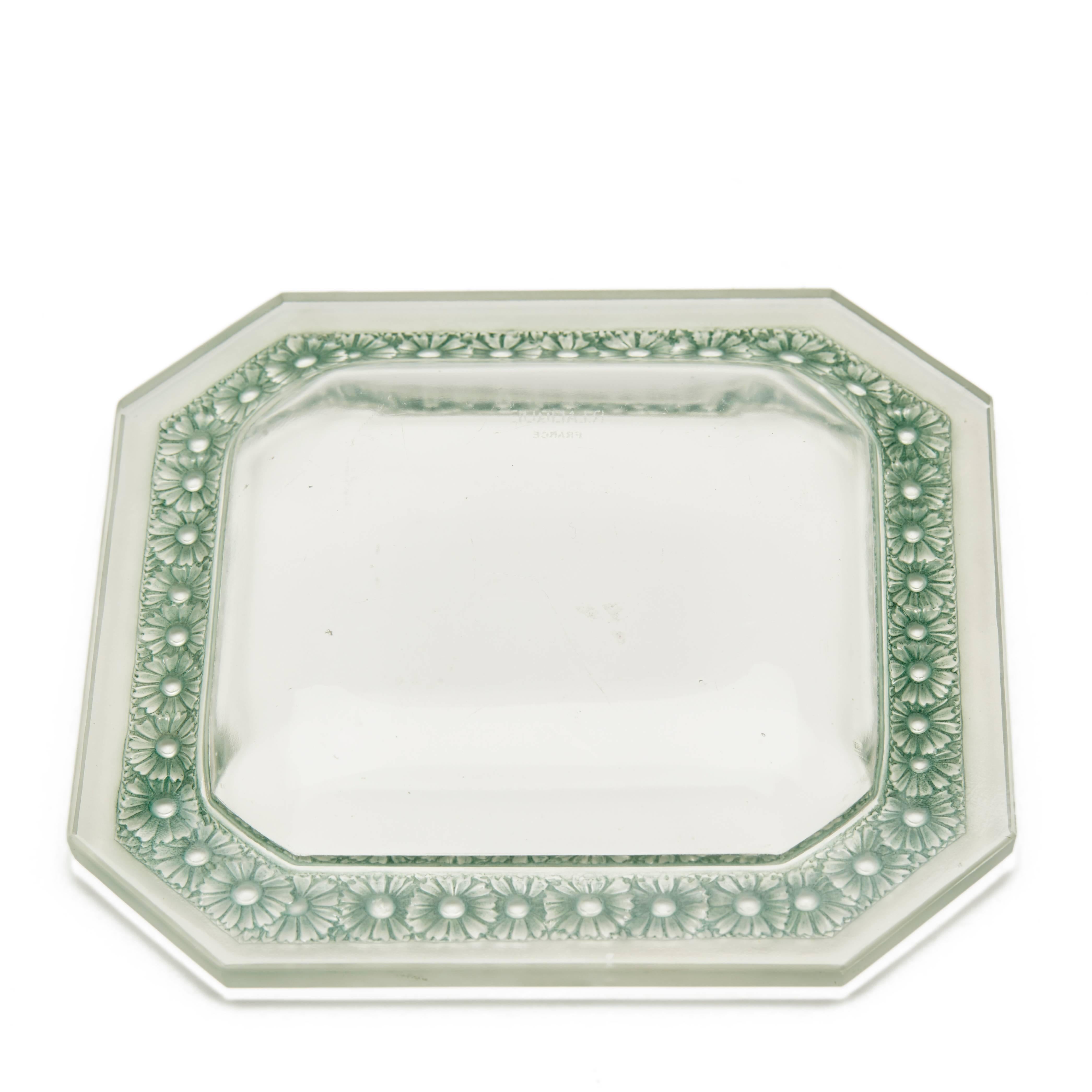 A fine vintage Rene Lalique Paquerettes pattern glass dish of square form the raised rim with canted corners and finely moulded with flower heads highlighted in green set with a frosted glass rim with a clear glass body. The dish has an R Lalique,