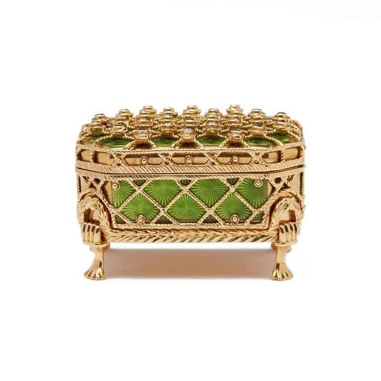 A stunning, modern limited edition Russian Faberge 18ct gold box mounted on a detachable fitted four leg stand. The rectangular box has a hinged cover decorated with green guilloche enamels overlaid with rope twist trellising the joints to the cover