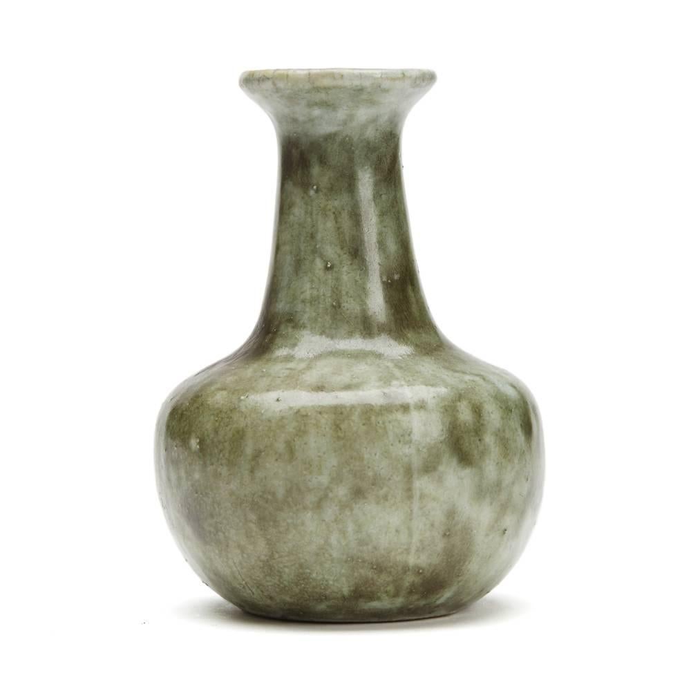 A fine Martin Brothers Martinware miniature stoneware bottle vase of rounded bulbous shape with a tapering neck decorated in mottled green glazes with pale blue glazes to the inside of the vase. With incised Martinware Southall 53-37-X2 mark to the