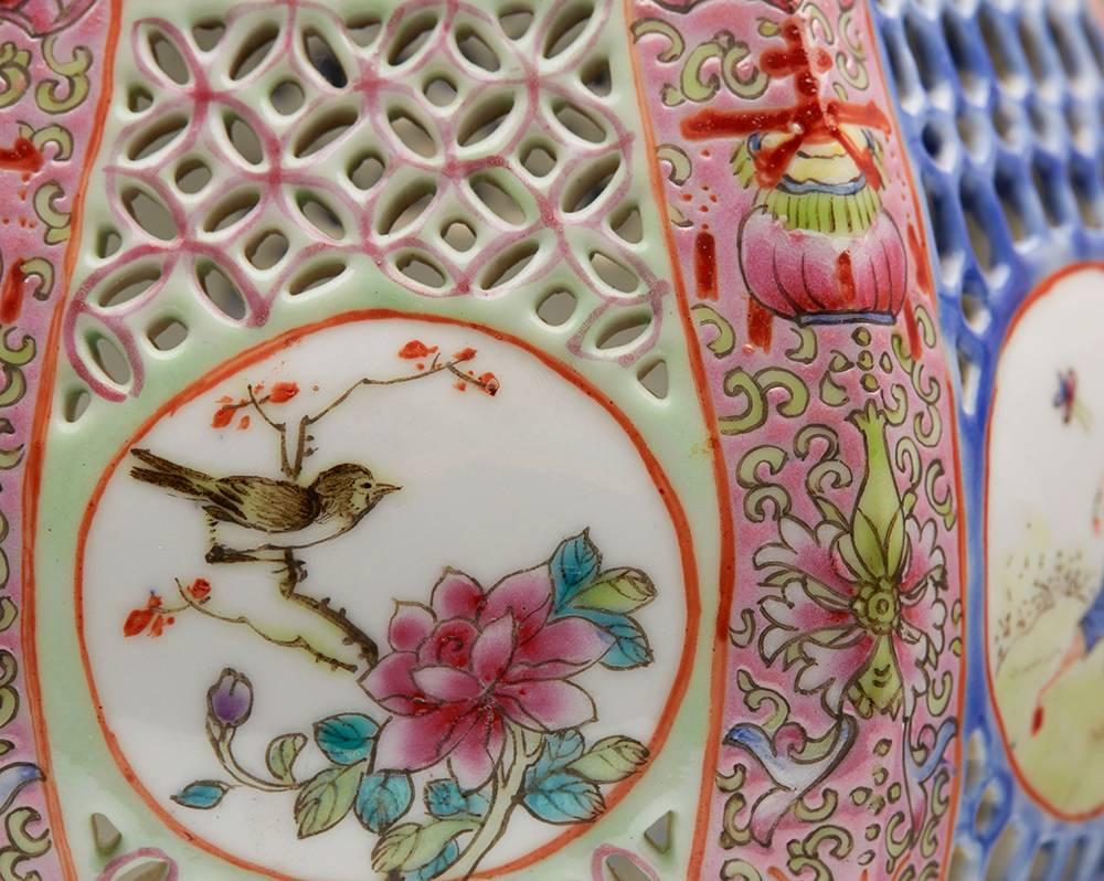 A fine pair vintage/antique Chinese porcelain pedestal lanterns decorated with pierced panels and floral designs in the famille rose palette dating from the 19th or early to mid 20th century.