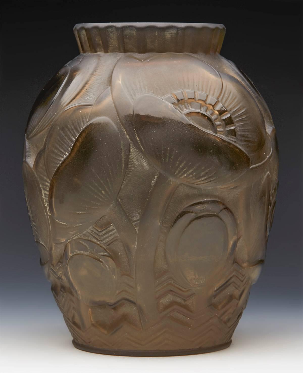 A fine Art Deco relief moulded smoked art glass vase with floral and seed pod designs by Pierre D'Avesn. The vase has a moulded makers mark to the base. For an identical style example see Christies Lot 456 sold on 13th October 2004 (sale no.