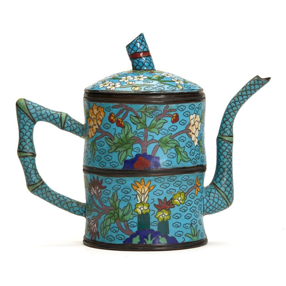 A fine antique Chinese cloisonné lidded teapot modelled as a section of bamboo with brightly colored floral designs on a turquoise ground. The teapot is not marked and believed to date from the 19th or early 20th century. There appears to be a red