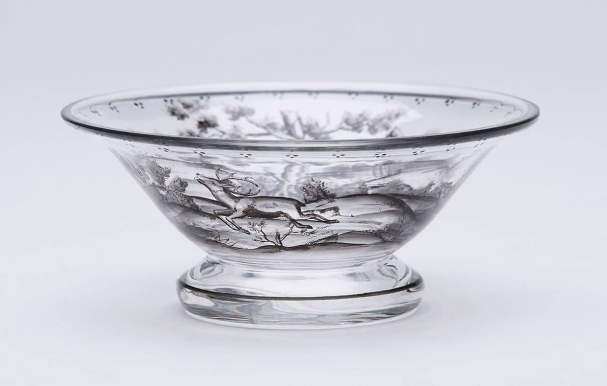 A stunning Bohemian schwarzlot (two tones of black) painted clear glass bowl depicting a hound chasing a stag through a tree lined landscape. Produced by Josef Lenhardt of Steinshonau possibly for Lobmeyr although not marked. 

Provenance: From a