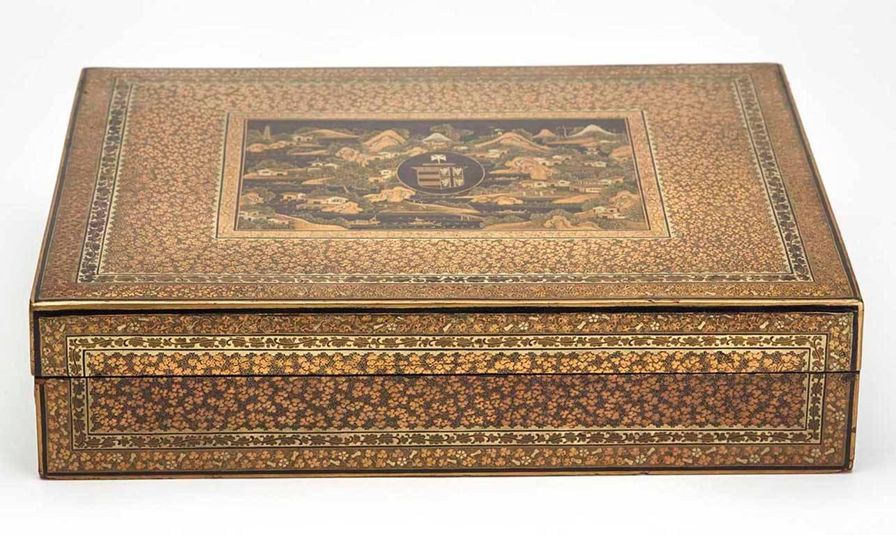 A stunning and rare antique Chinese armorial games box of rectangular form with over 110 matching armorial mother-of-pearl gaming counters. The black lacquer box is finely decorated with a central Chinese landscape scene, the centre with an armorial