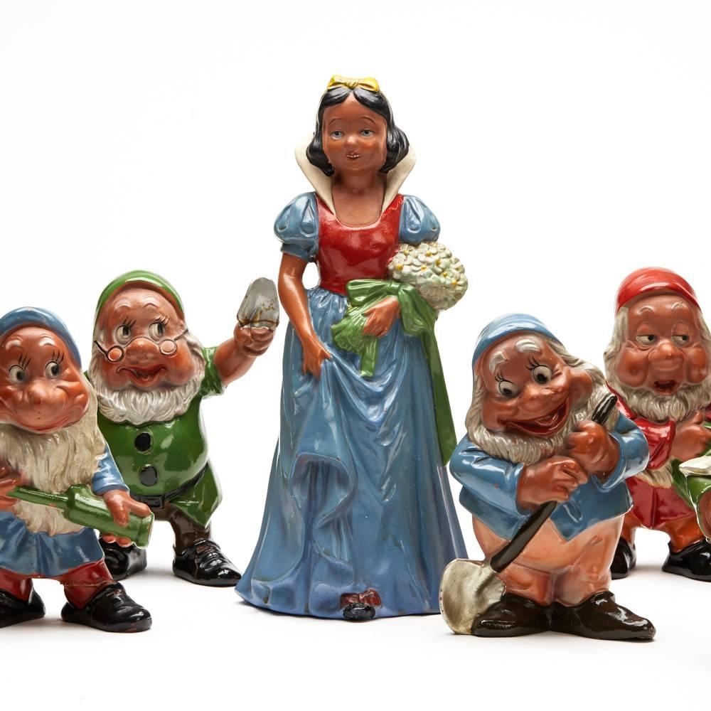 A fine and rare vintage continental snow white and the seven dwarfs set of terracotta figures from the tale by the Brothers Grimm and animated by Disney and released in 1938. The figures we believe were probably released around this time and are