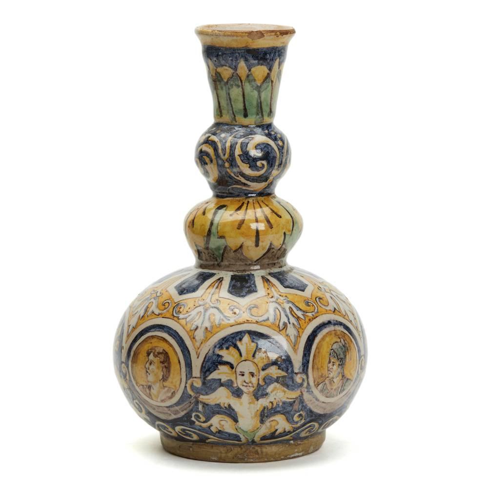 A stunning and rare antique Italian Maiolica pottery triple gourd vase hand-painted with portraits set amidst classical and scroll designs in typical Maiolica yellow, blue, green and white colours. The earthenware vase a squat rounded bulbous body