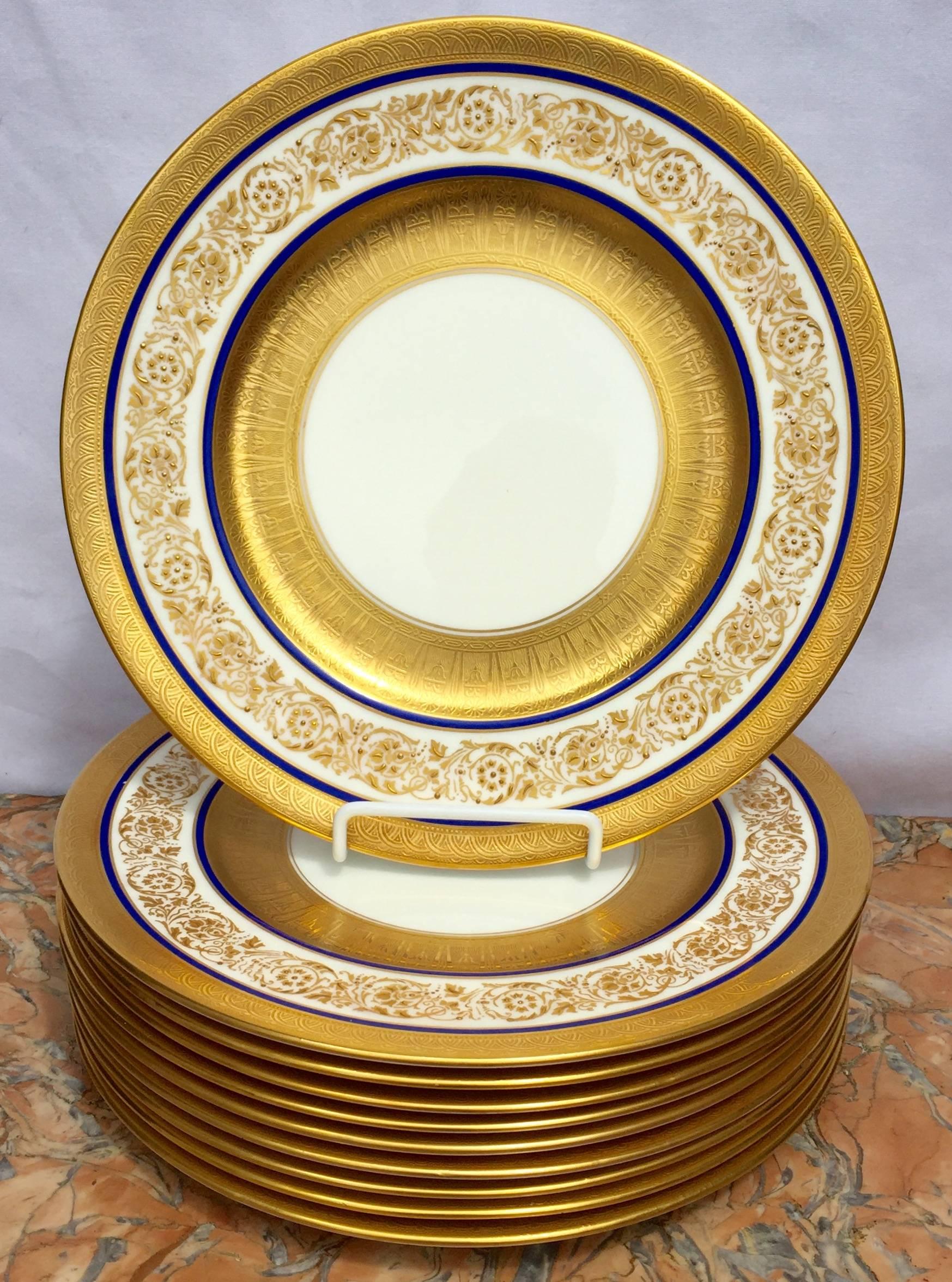 These are absolutely spectacular. The outer edge is raised in 24-karat gold, then you have between two fine lines of cobalt blue an encrusted gilt foliate and floral border on a white background. Next is an Egyptian inspired wide gold inner border.