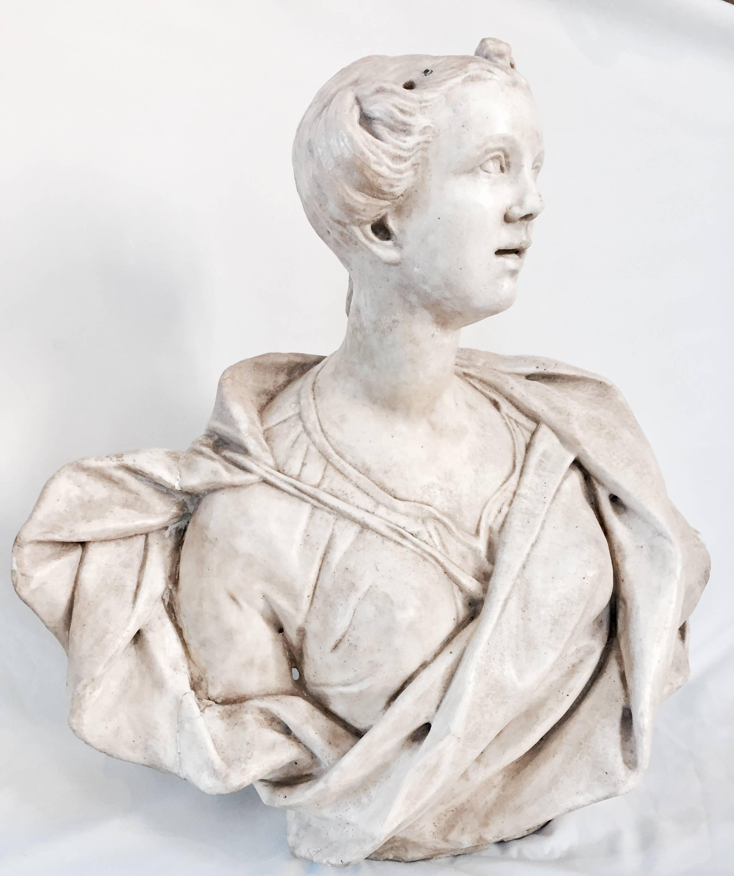 This lifesize bust of a European lady was exquisitely carved out of Statuario marble in the late 1600s. The creases in the silk dress have debth and are an indication that the sitter was aristocratic. A flower adorns her hair due.