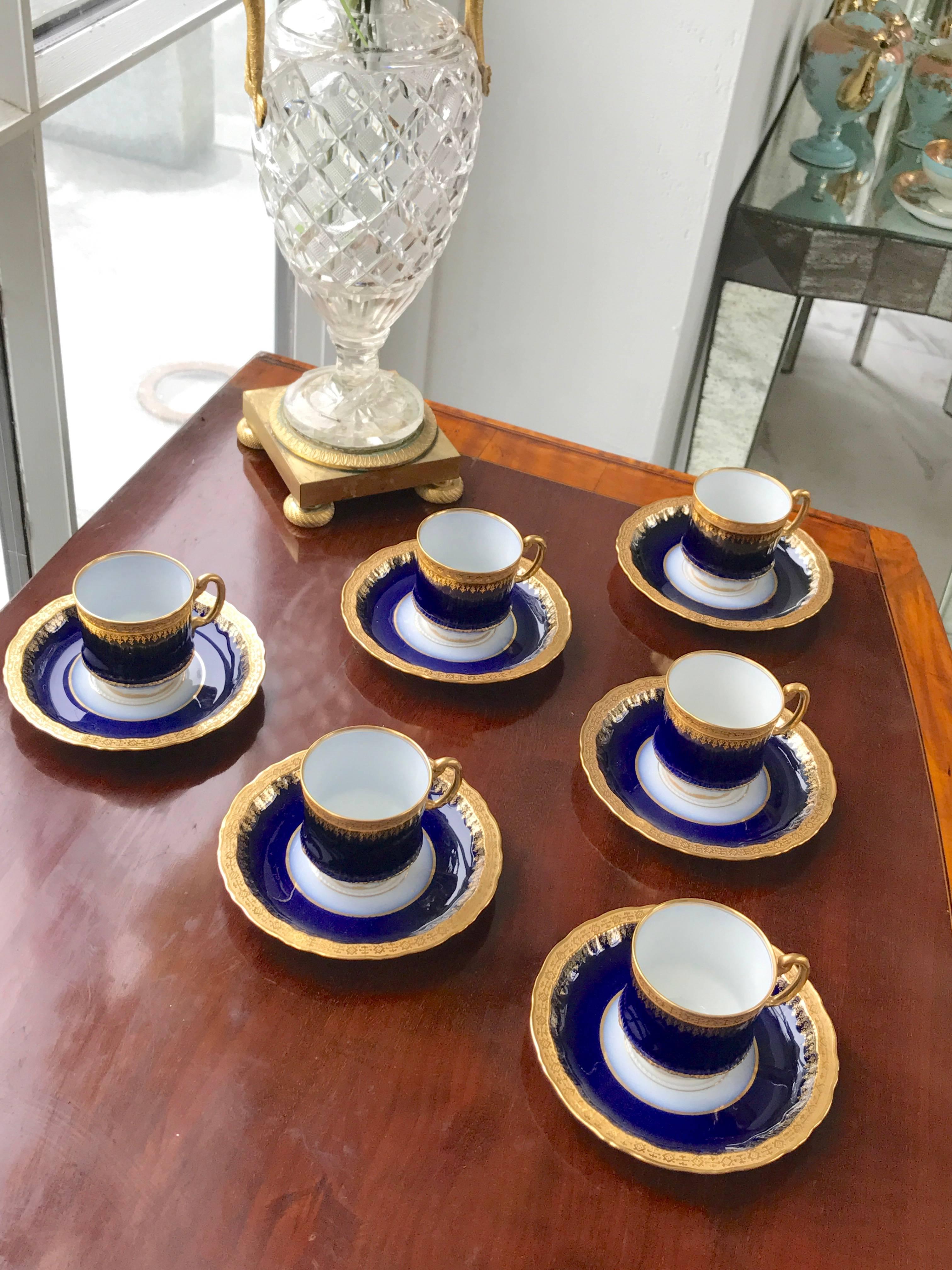 These very fine nine bone china demi-tasse cup and saucers were manufactured by Limoges in France. There beautiful cobalt blue border with 24-karat gold encrusted rim on the in and outside is a rare find for this pattern! They are complimentary to